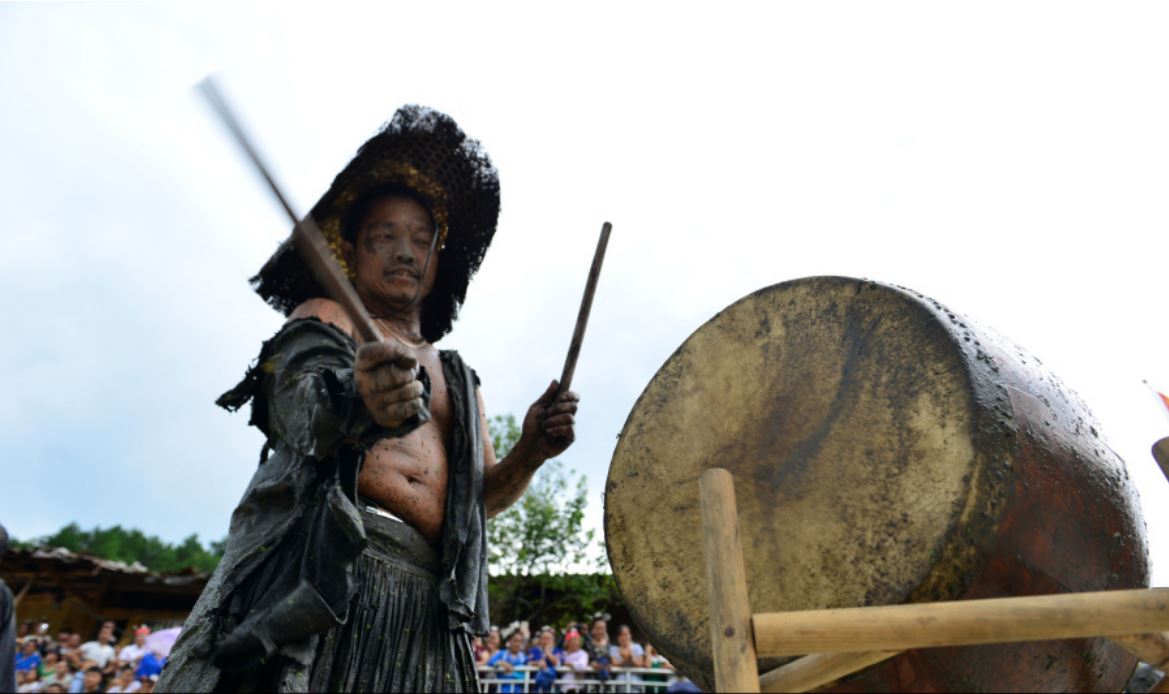 Miao Playing Drum on "Dog Carrying Day"